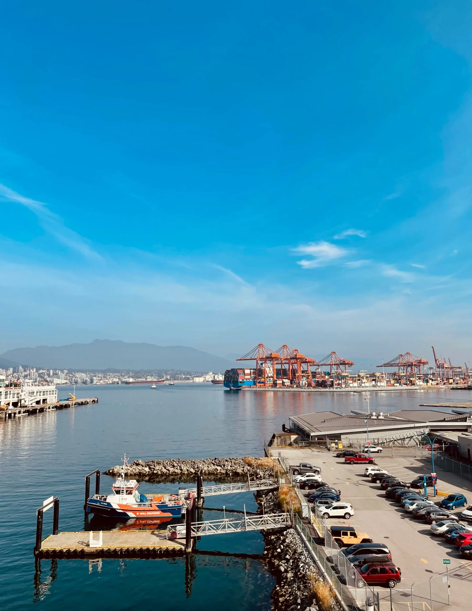 a dock with boats and cars
