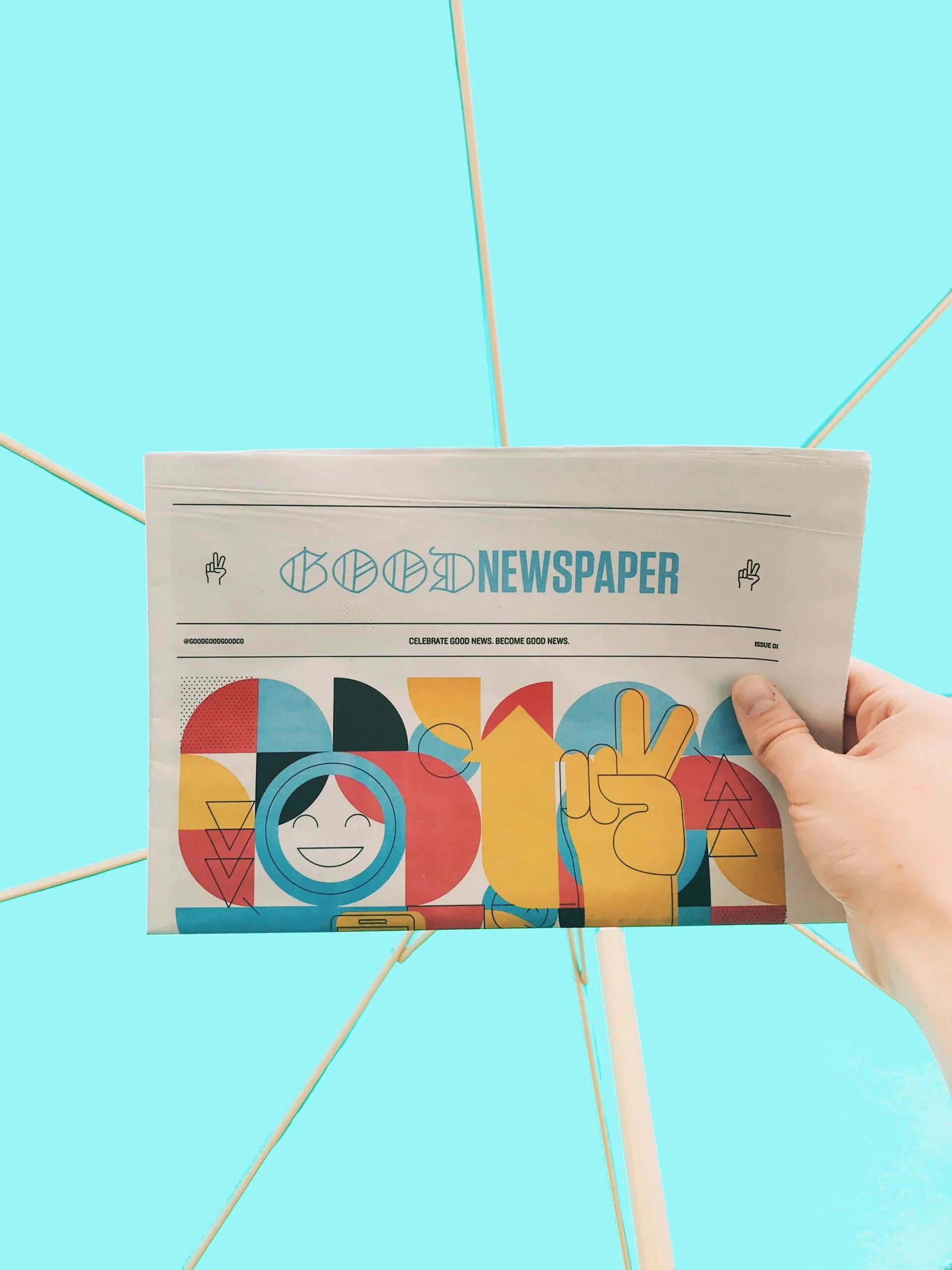 person holding newspaper article